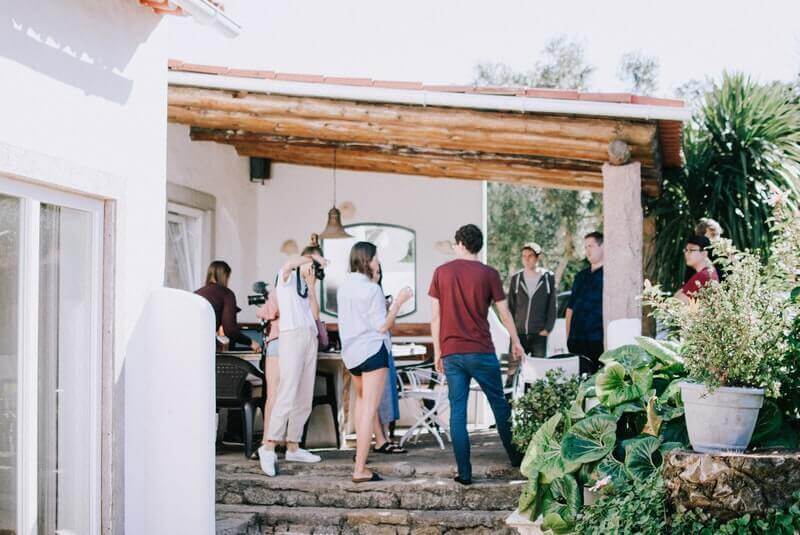 a group of people standing outside a sober living house, sober living house, sober living houses near me, sober living