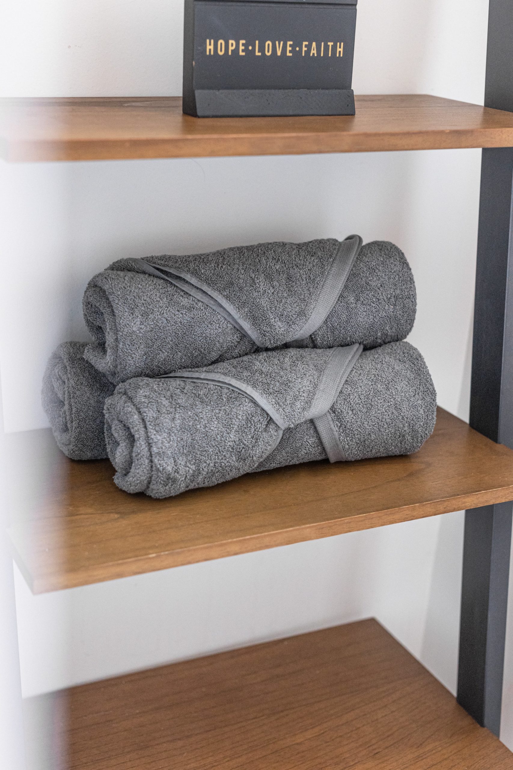 grey towel on a shelf