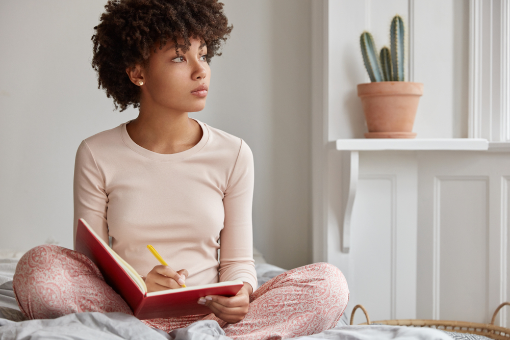 African American woman journaling for her mental health